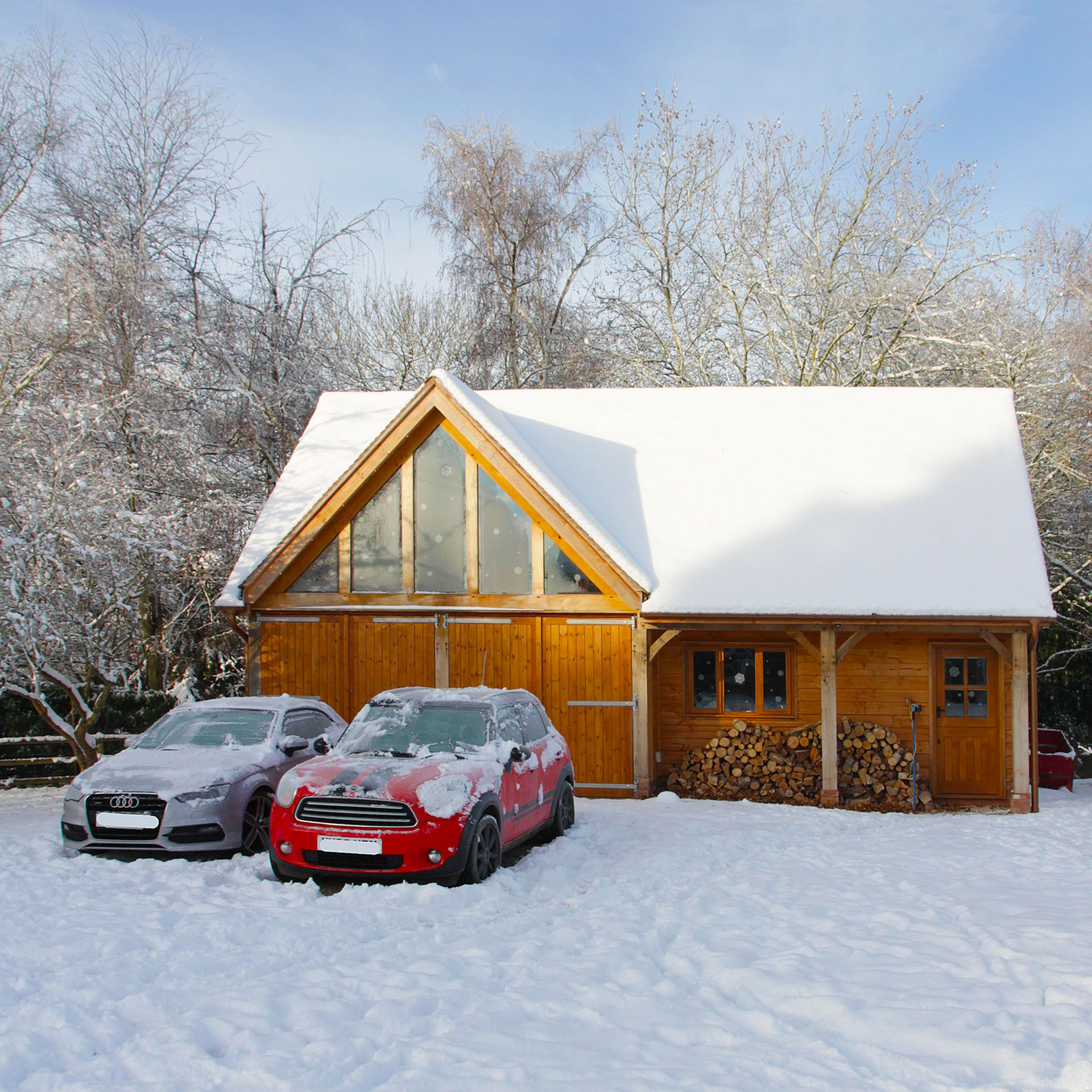 oak framed garage in the english snow